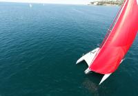 trimaran charter yacht sailing with gennaker on mast